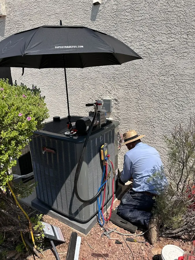 HVAC technician performing outdoor AC maintenance in Canton